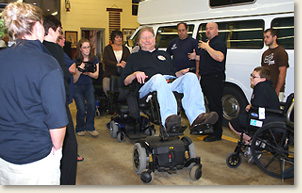 Scott Elliott, executive director of the Progressive Center for Independent Living, demonstrating how to operate a power wheelchair at their Adaptive Equipment Demo
